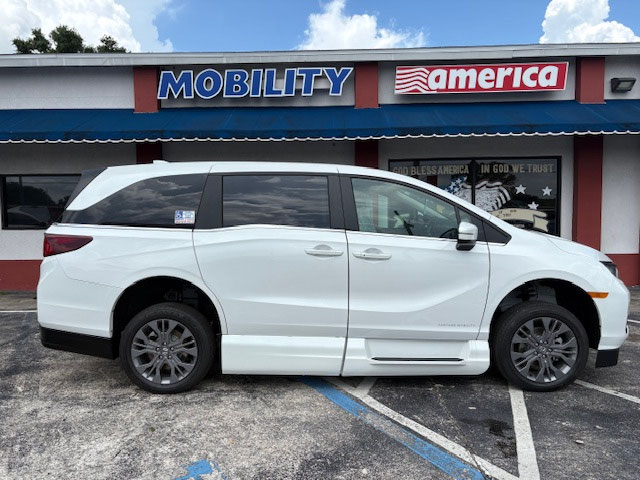 A 2025 Honda Odyssey Touring wheelchair van, side view, parked outside the Mobility America showroom
