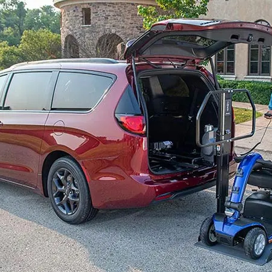 Bruno Joey inside platform lift loading a scooter into a minivan