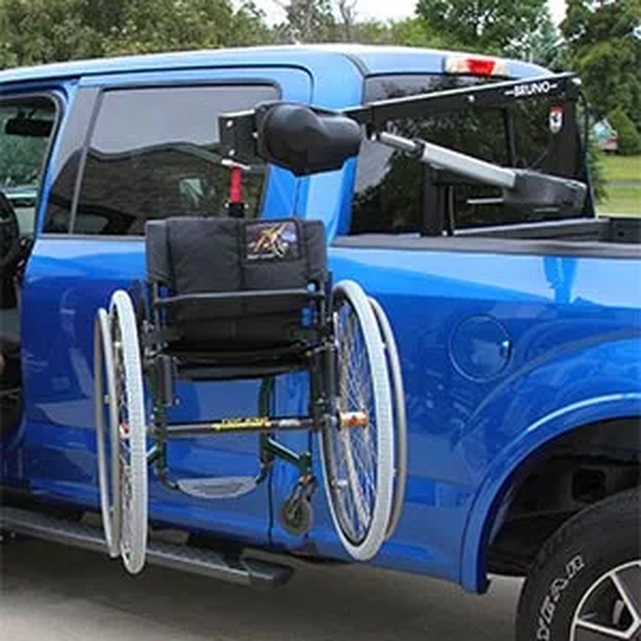 Bruno Out-Rider lift raising a wheelchair into a pickup truck bed