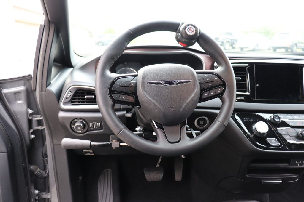 A hand-control lever fitted to the left of the steering column in a minivan