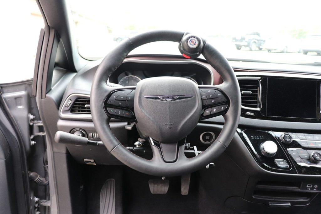 A hand-control lever and steering knob fitted in a minivan