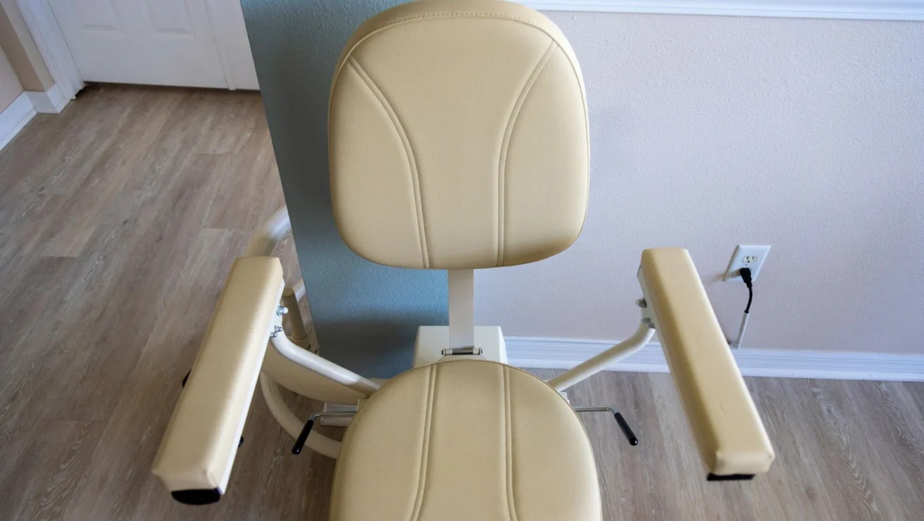 A Harmar Helix curved stairlift chair installed on its curved rail in a home