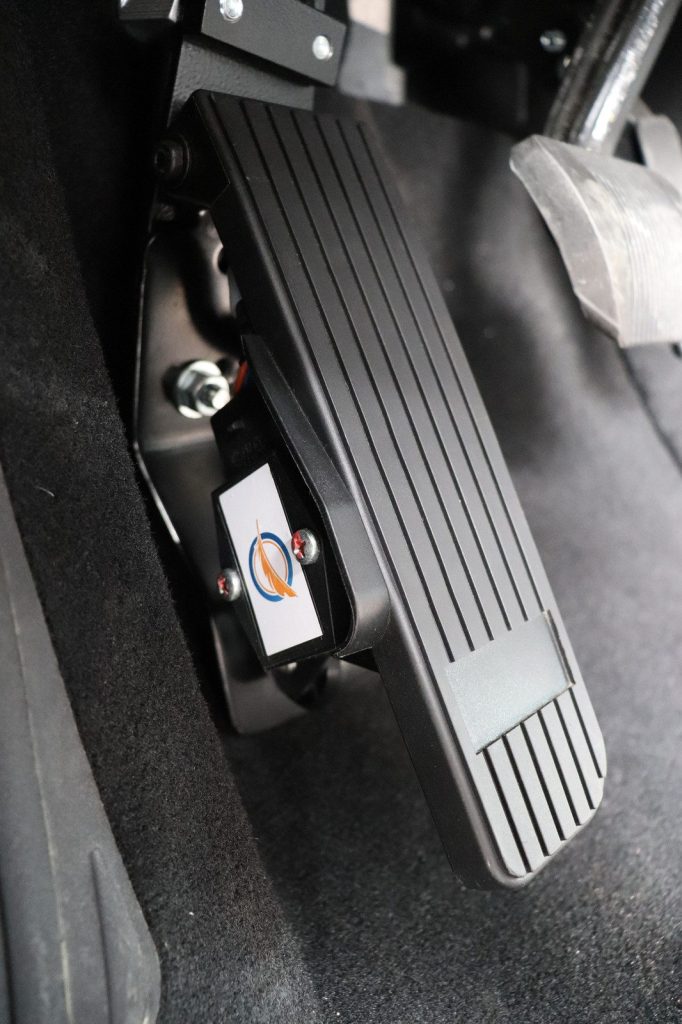 A left-foot accelerator pedal fitted to the left of the brake pedal