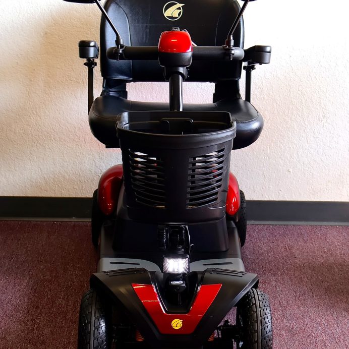 Pre-owned red Golden Buzzaround EX 4-wheel mobility scooter, photographed at the Mobility America showroom in Lakeland