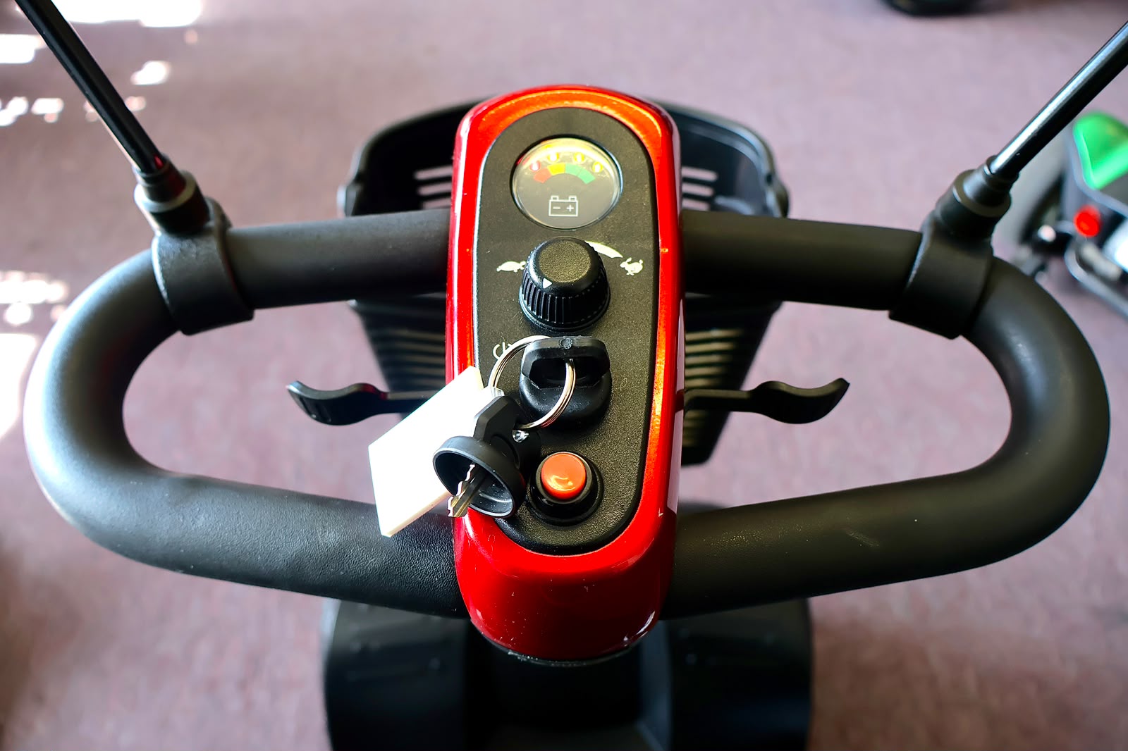 Pre-owned red Golden Buzzaround EX 4-wheel mobility scooter, photographed at the Mobility America showroom in Lakeland