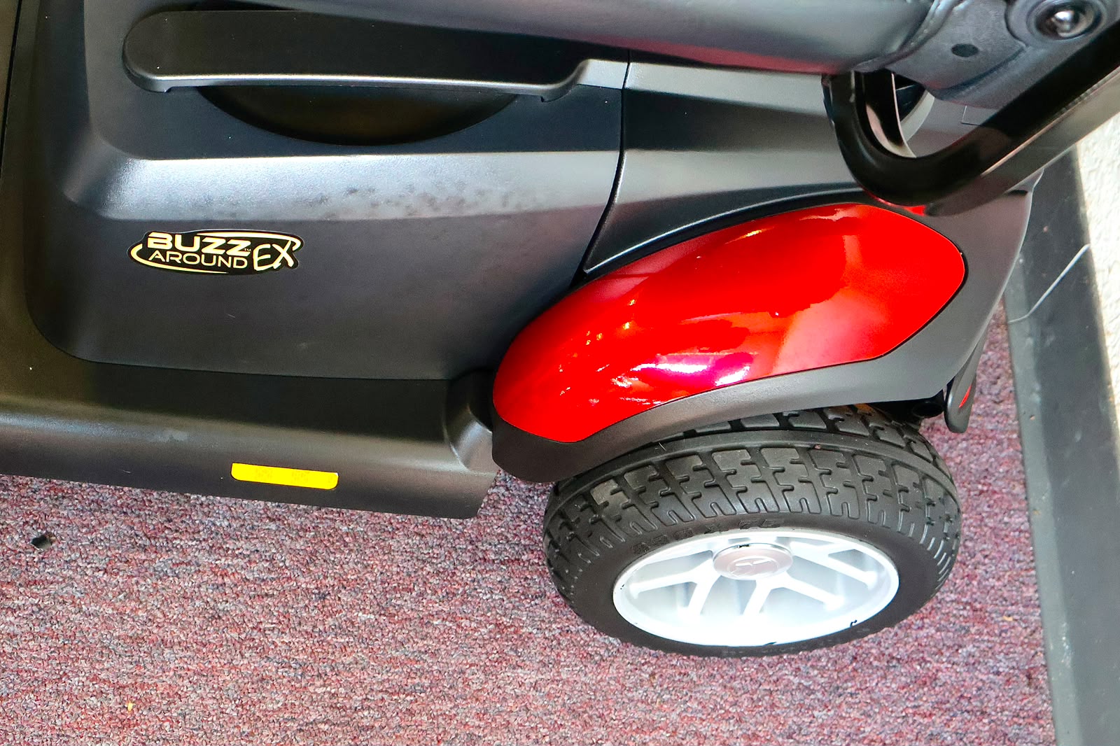 Pre-owned red Golden Buzzaround EX 4-wheel mobility scooter, photographed at the Mobility America showroom in Lakeland