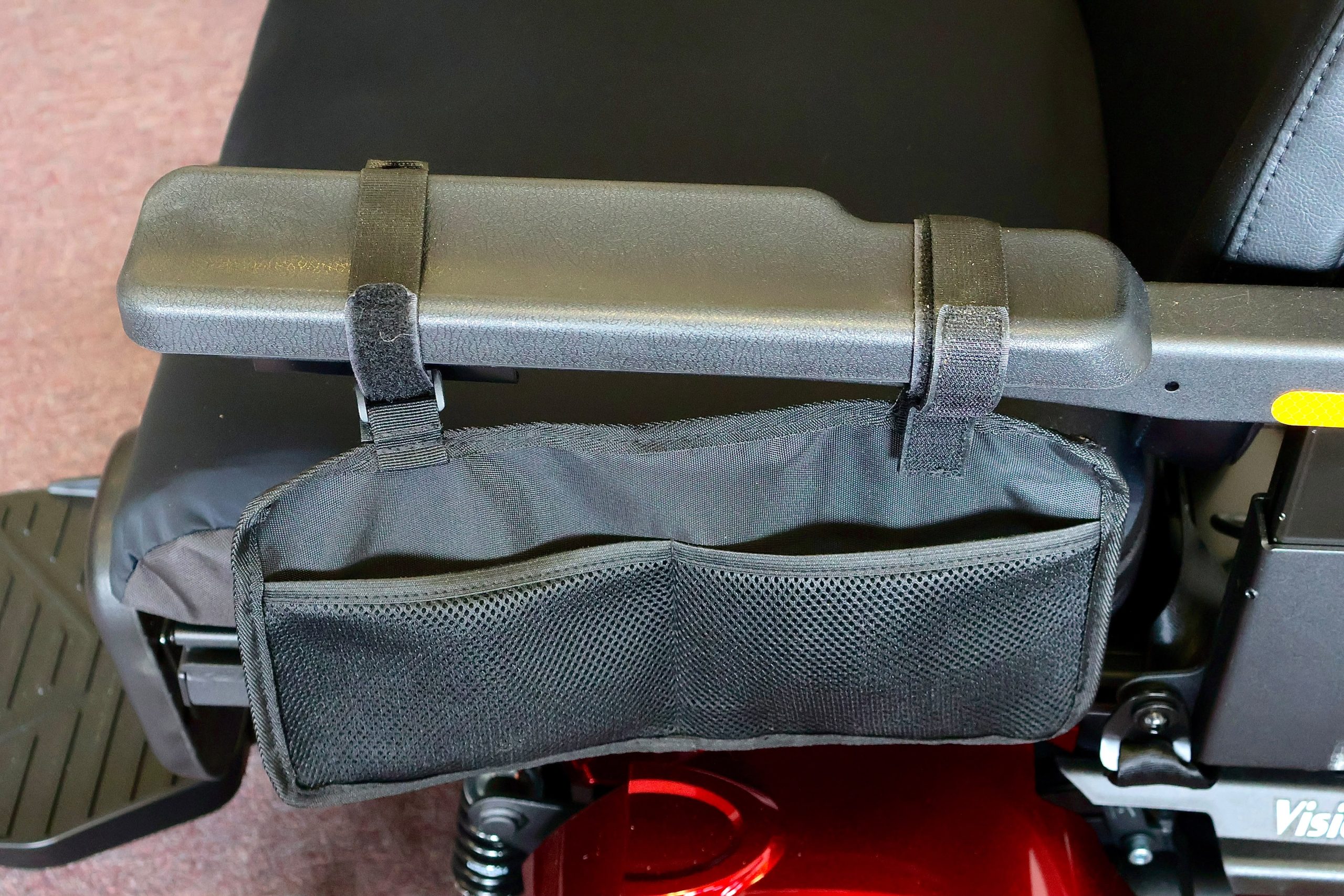Pre-owned red Merits Vision Ultra rehab power wheelchair with manual attendant control, photographed at the Mobility America showroom in Lakeland