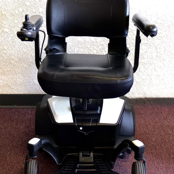 Pre-owned white Pride Go Chair power wheelchair, photographed at the Mobility America showroom in Lakeland