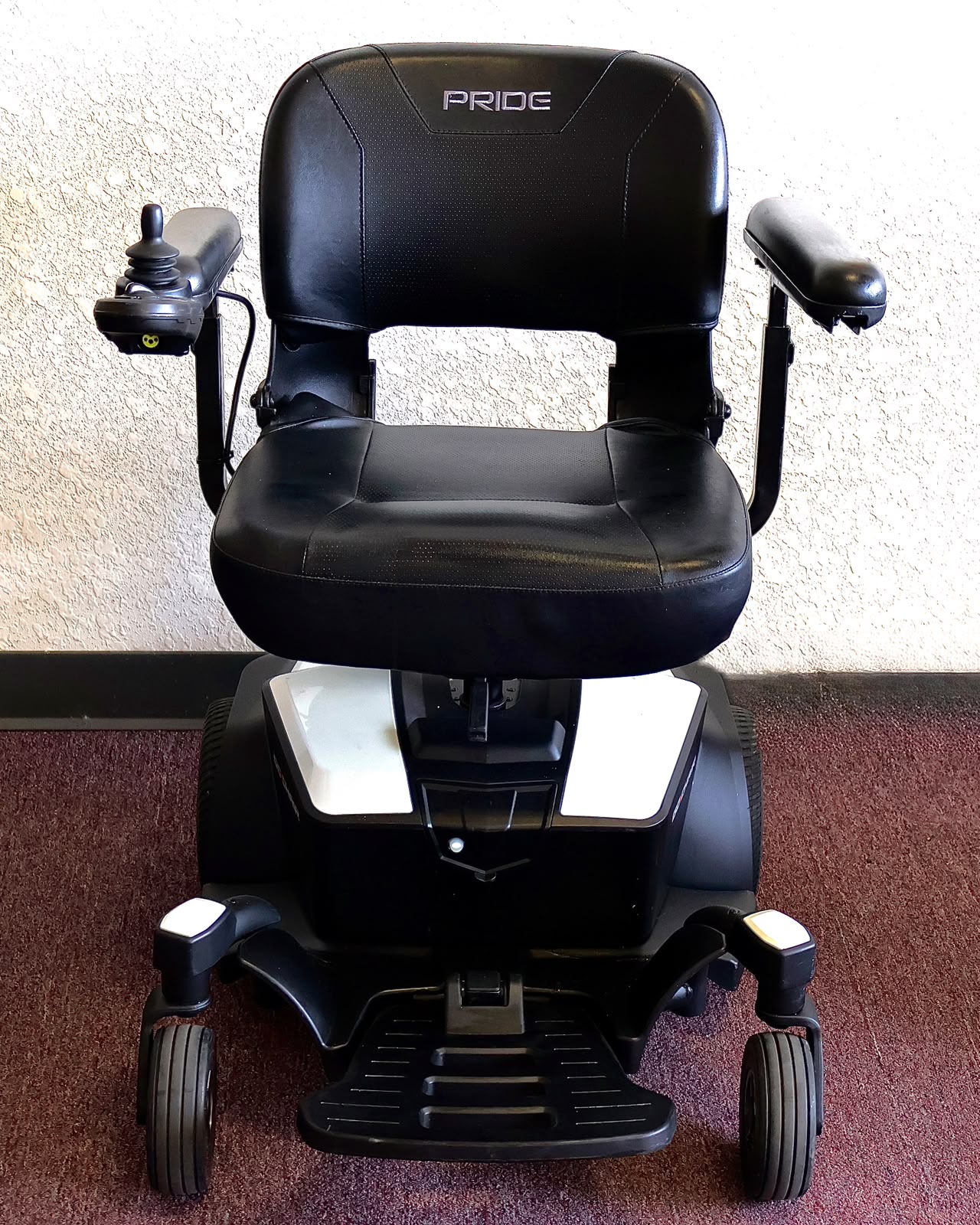 Pre-owned white Pride Go Chair power wheelchair, photographed at the Mobility America showroom in Lakeland