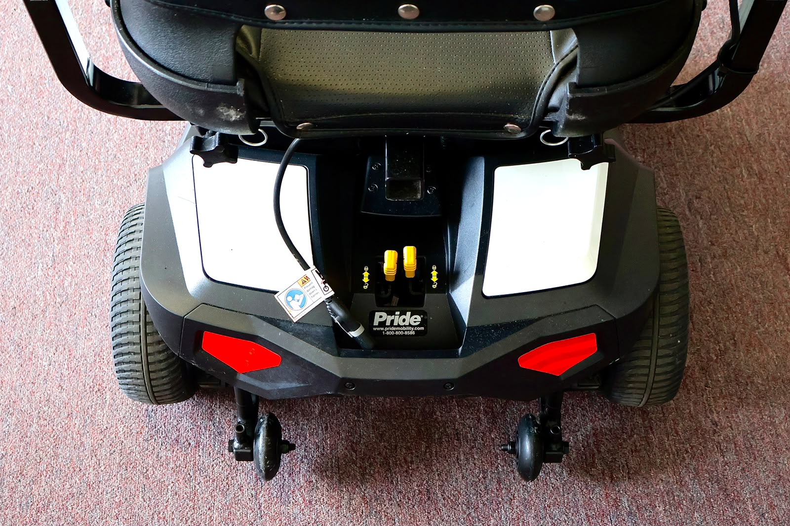 Pre-owned white Pride Go Chair power wheelchair, photographed at the Mobility America showroom in Lakeland