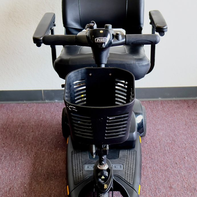 Pre-owned black Pride Go-Go Elite Traveller 3-wheel mobility scooter, photographed at the Mobility America showroom in Lakeland