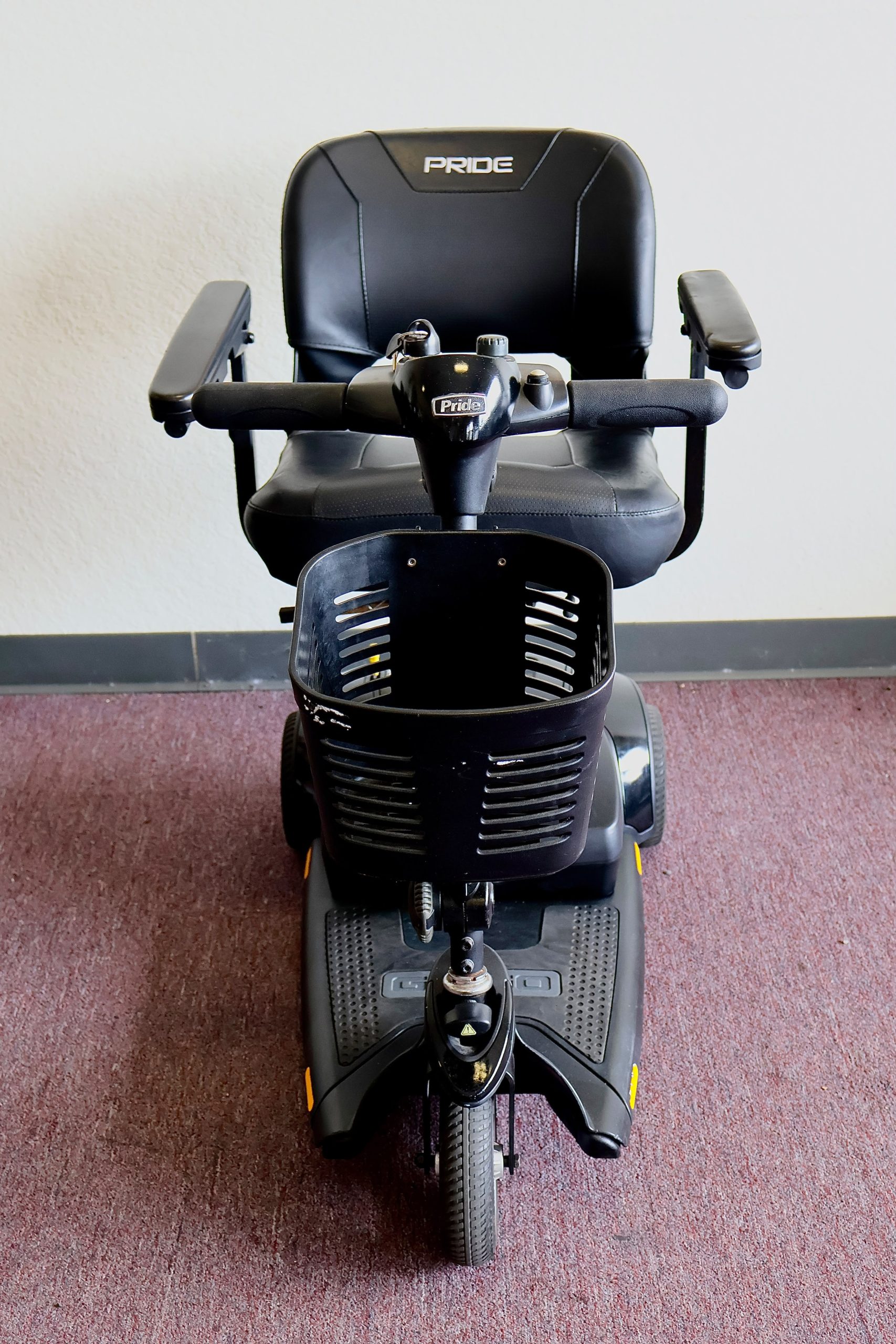 Pre-owned black Pride Go-Go Elite Traveller 3-wheel mobility scooter, photographed at the Mobility America showroom in Lakeland