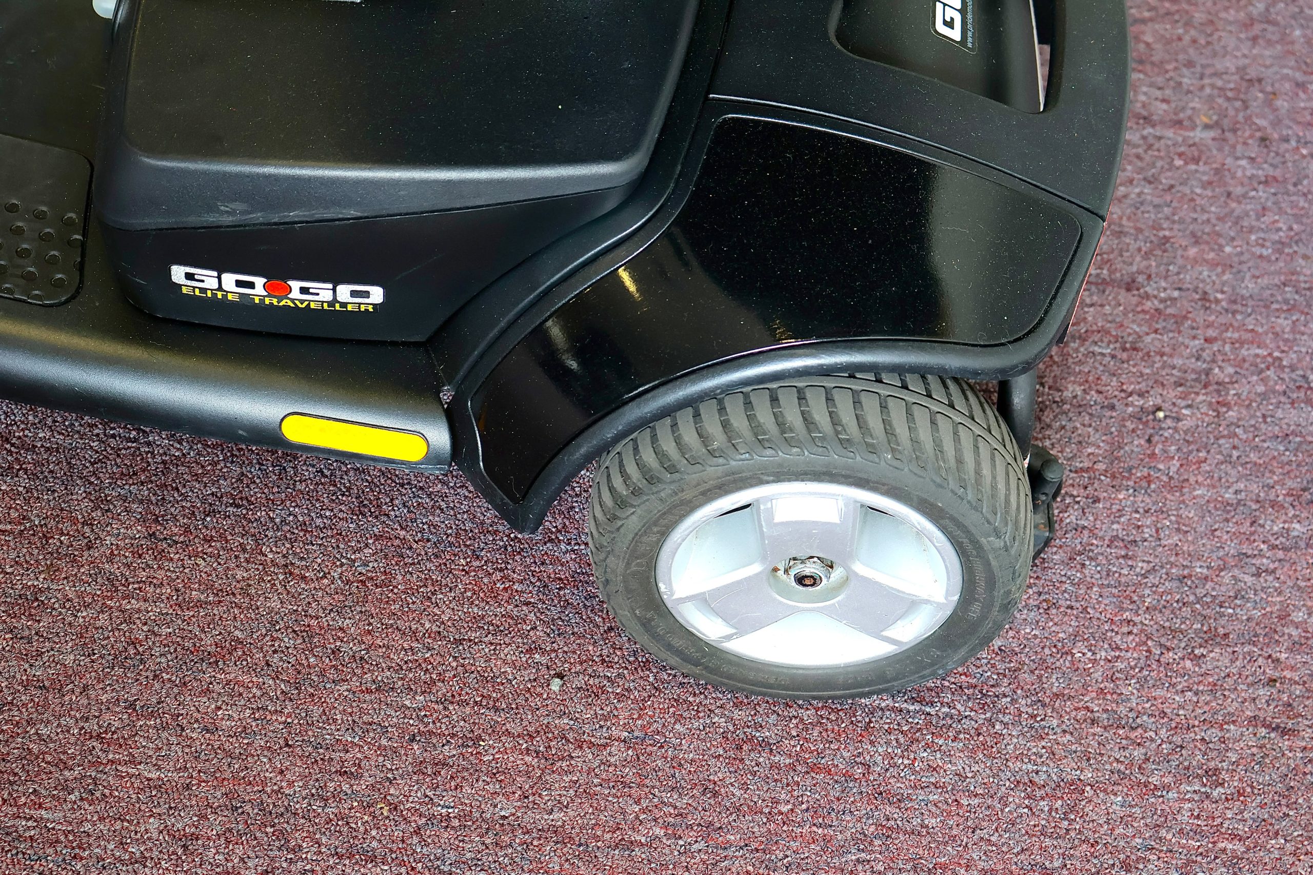 Pre-owned black Pride Go-Go Elite Traveller 3-wheel mobility scooter, photographed at the Mobility America showroom in Lakeland