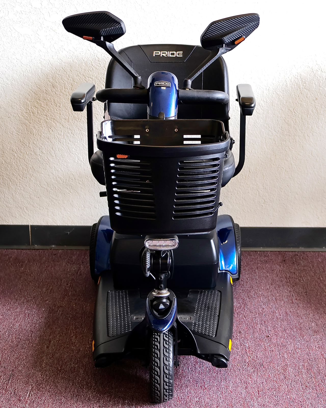 Pre-owned blue Pride Go-Go Sport 3-wheel mobility scooter, photographed at the Mobility America showroom in Lakeland