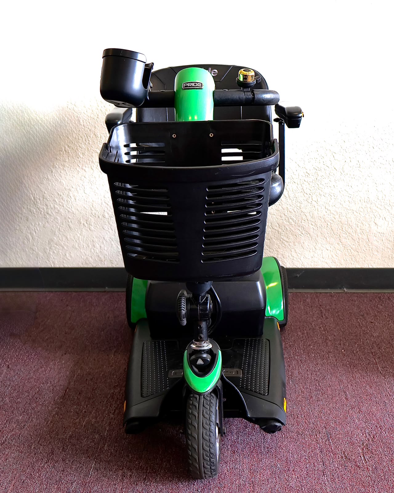 Pre-owned green Pride Go-Go Sport 3-wheel mobility scooter, photographed at the Mobility America showroom in Lakeland