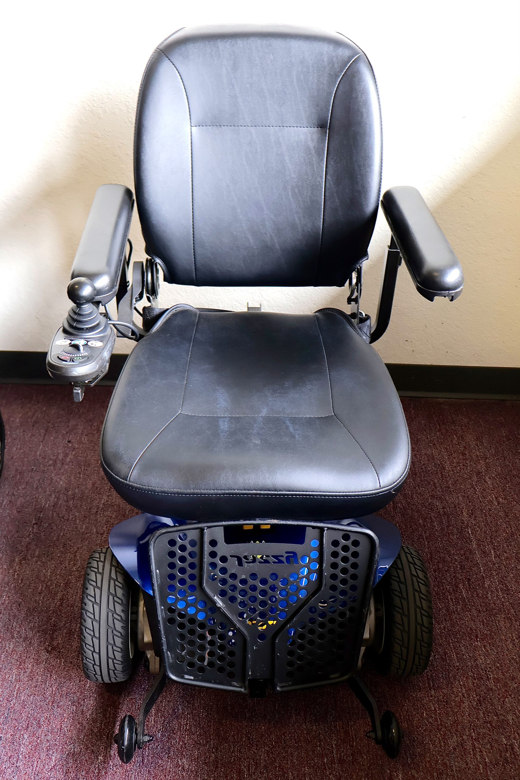 Pre-owned blue Pride Jazzy power wheelchair, photographed at the Mobility America showroom in Lakeland