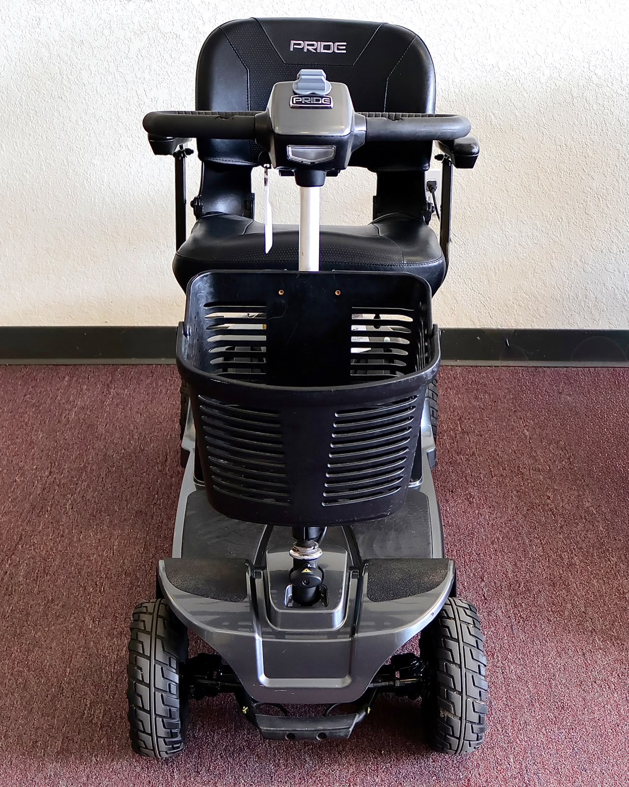 Pre-owned grey Pride Revo 2.0 4-wheel mobility scooter, photographed at the Mobility America showroom in Lakeland