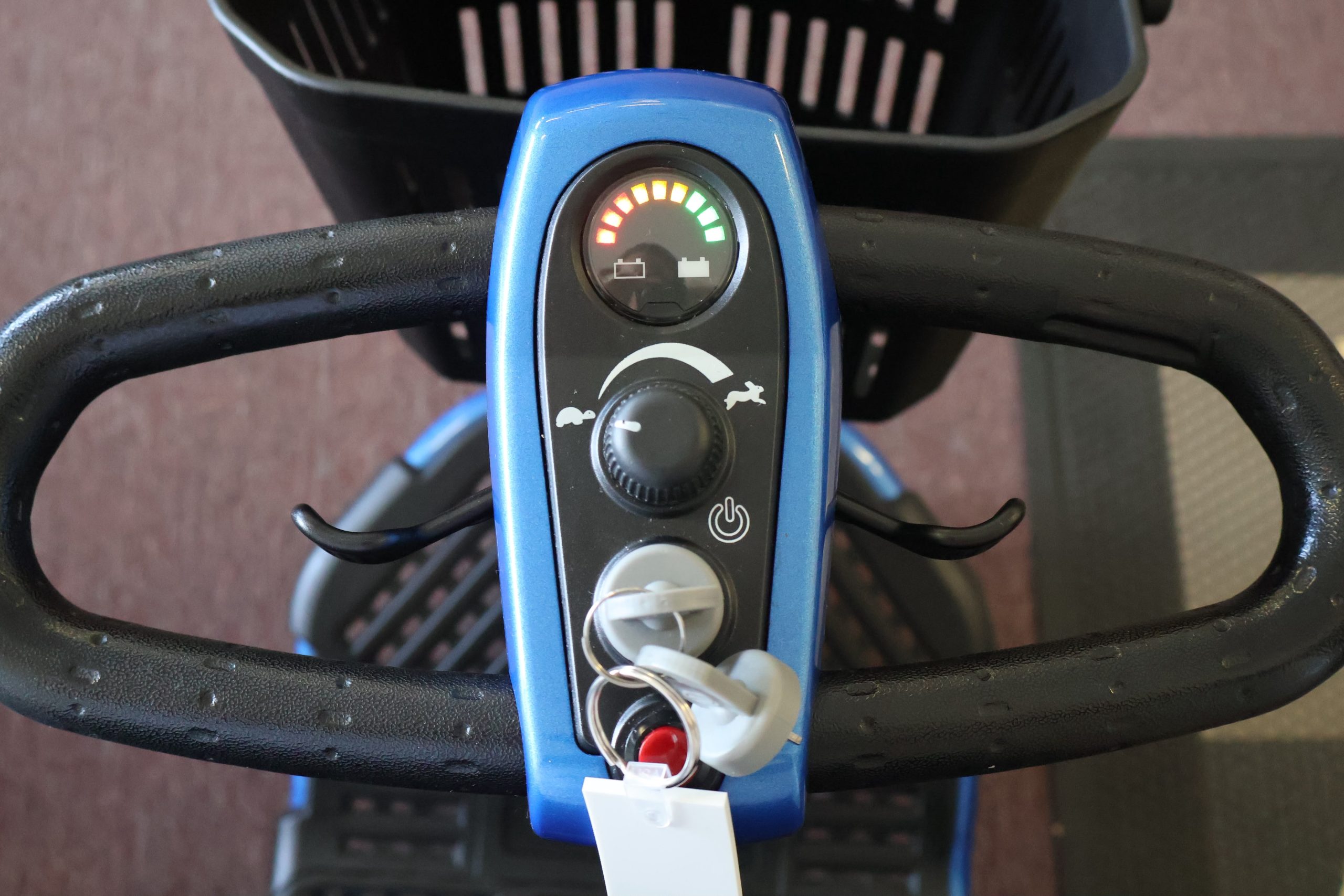 Pre-owned red Pride Victory 9 3-wheel mobility scooter, photographed at the Mobility America showroom in Lakeland