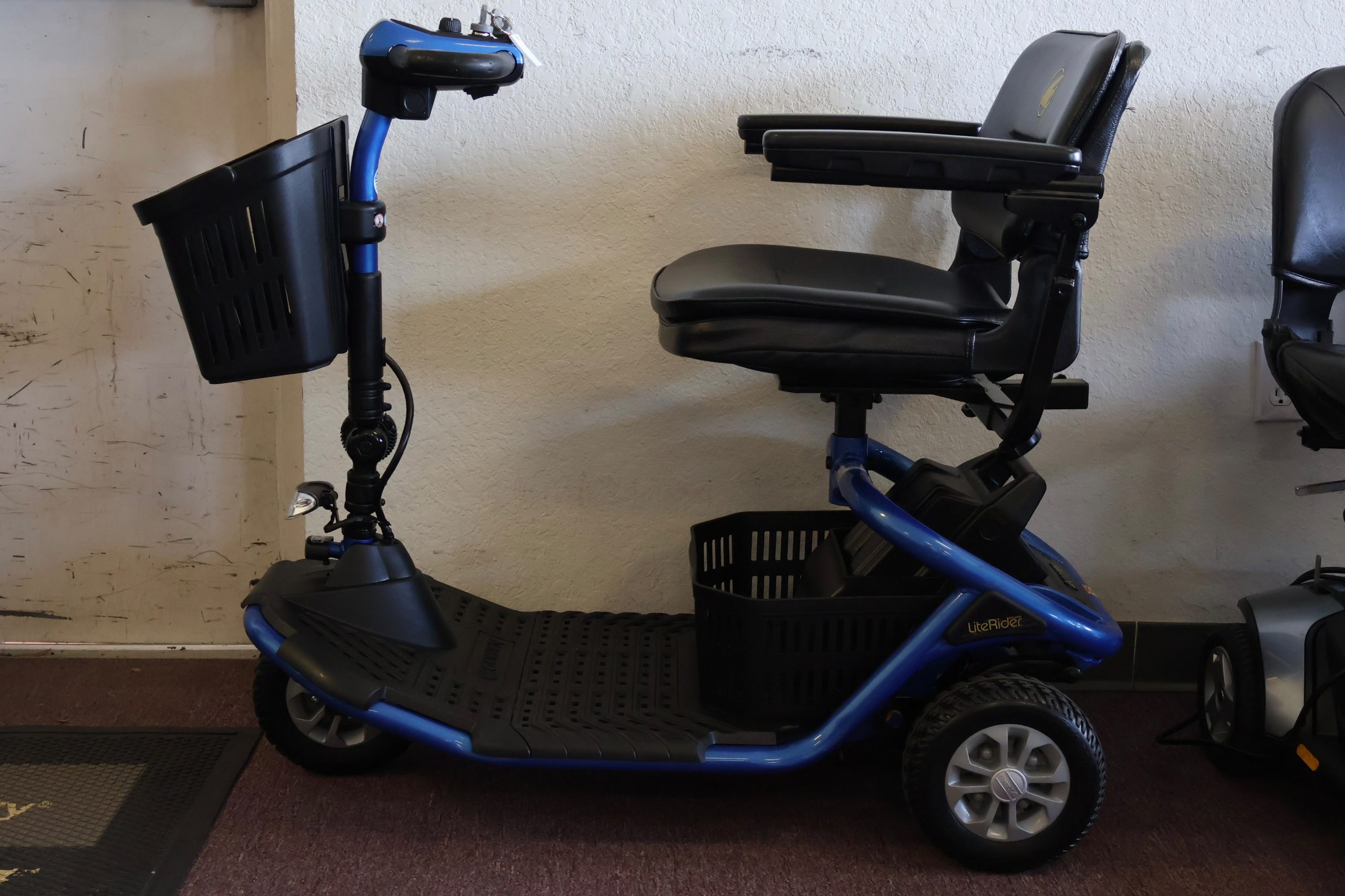 Pre-owned red Pride Victory 9 3-wheel mobility scooter, photographed at the Mobility America showroom in Lakeland