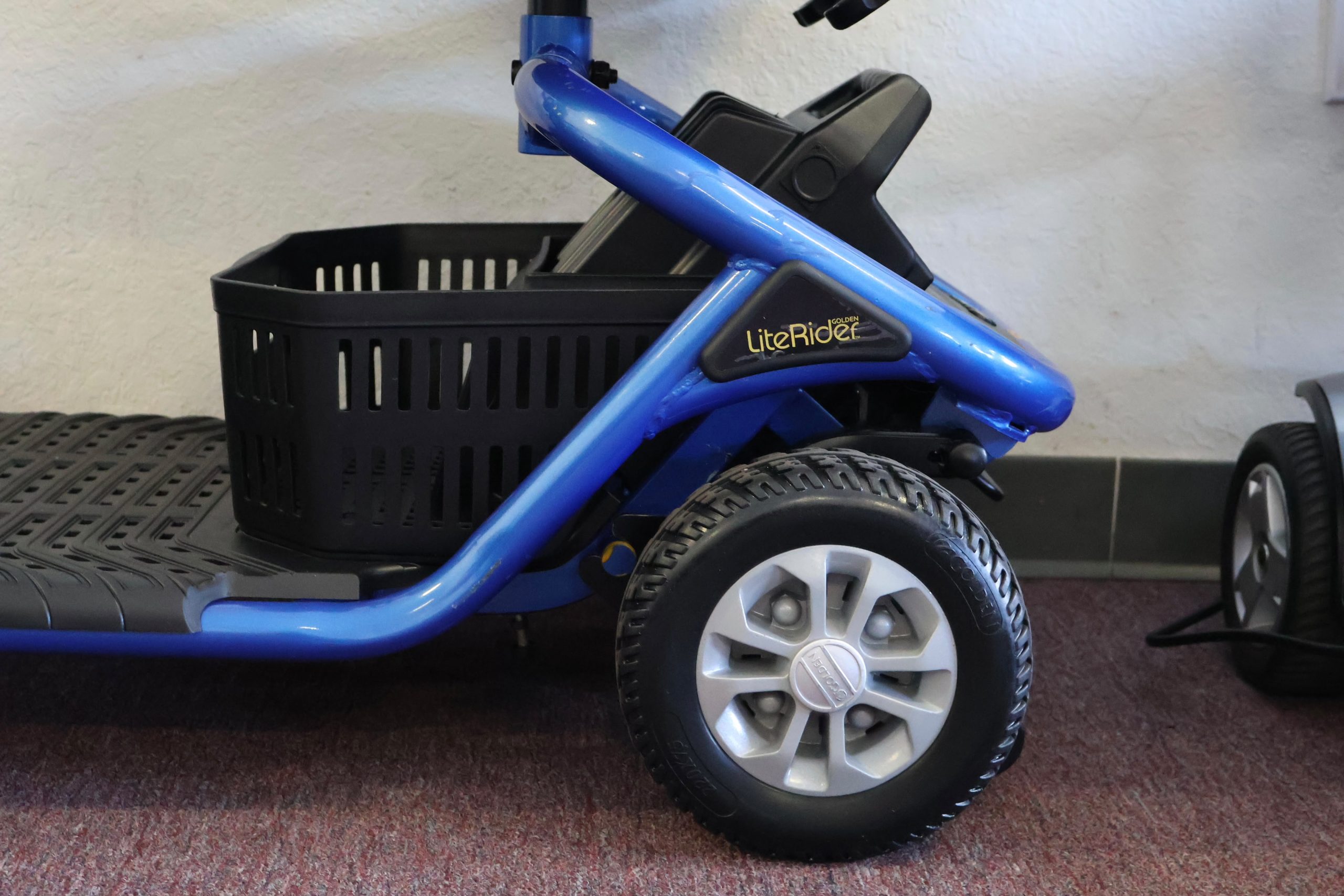 Pre-owned red Pride Victory 9 3-wheel mobility scooter, photographed at the Mobility America showroom in Lakeland