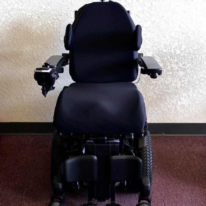 Pre-owned Quantum iLevel rehab power wheelchair in digital camo, photographed at the Mobility America showroom in Lakeland