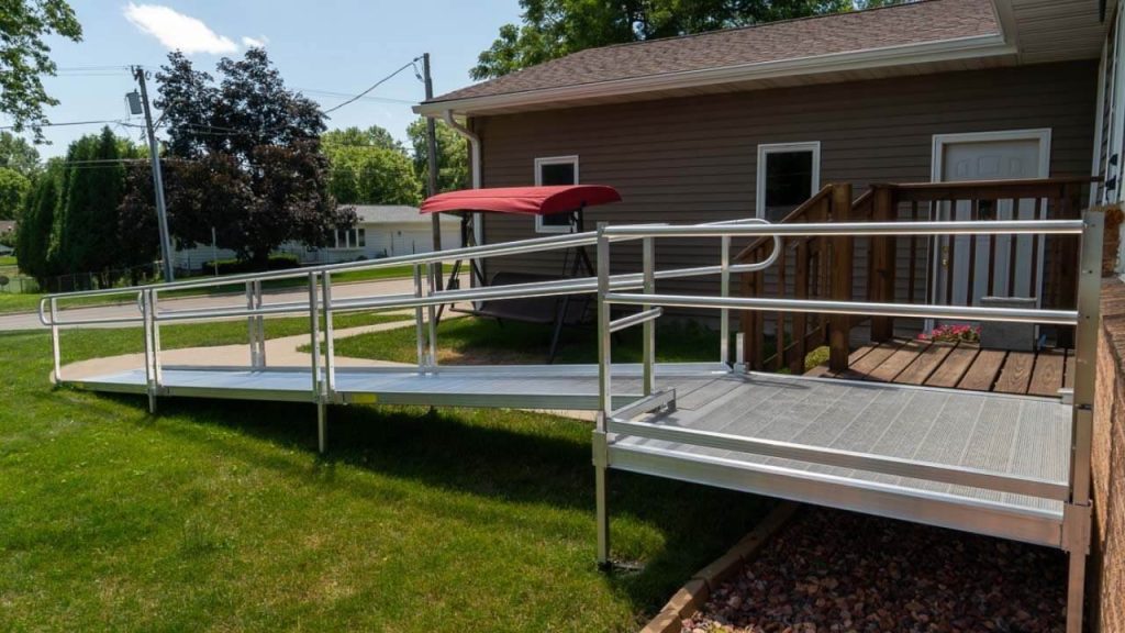 A wheelchair ramp installed with a handrail