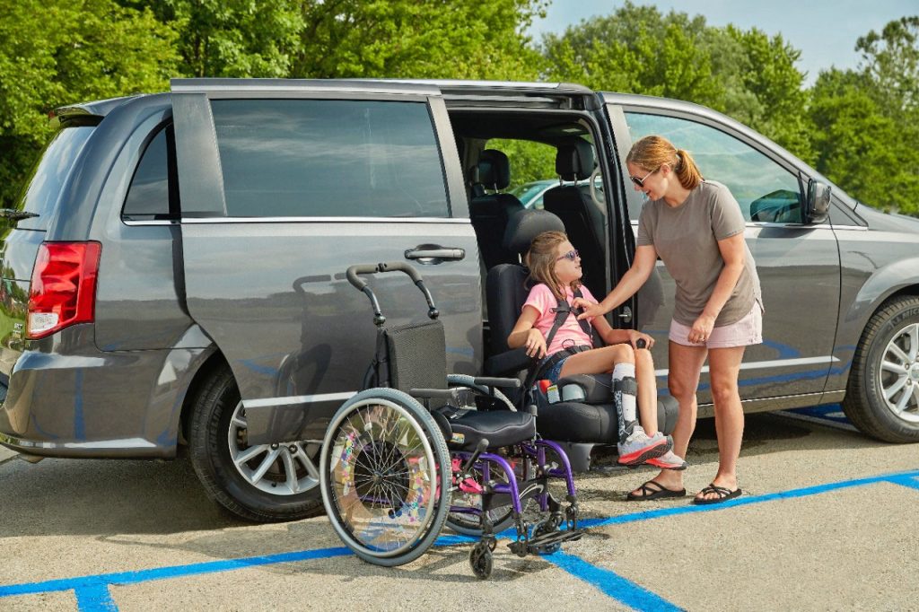 A powered transfer seat rotated out of a vehicle door frame and lowered ready for transfer