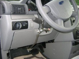 A hand-control lever fitted beside the steering column, push down to brake and pull back for gas