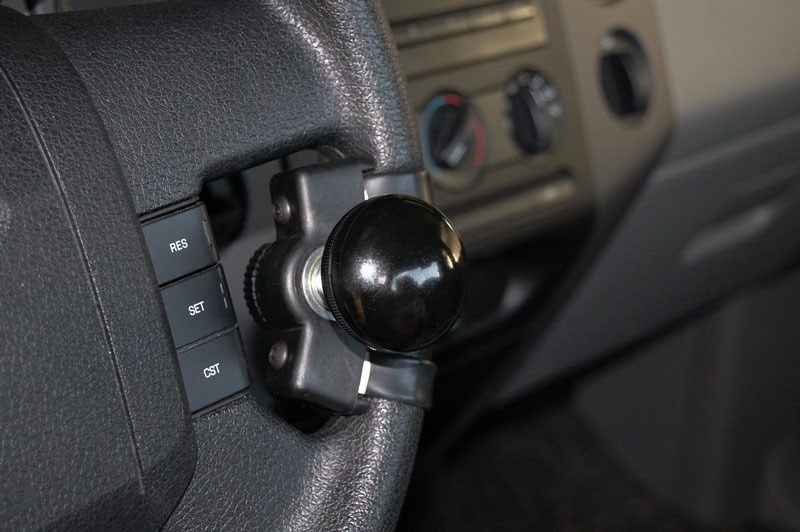 A ball-grip spinner knob with quick-release base fitted to a steering wheel