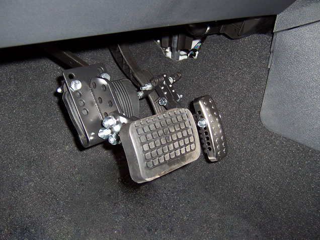An adjustable brake or clutch pedal extension clamped to the original pedal