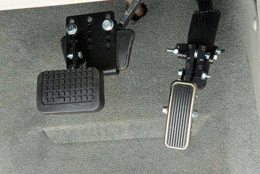 An adjustable accelerator pedal clamp with a locking screw and adjustable reach